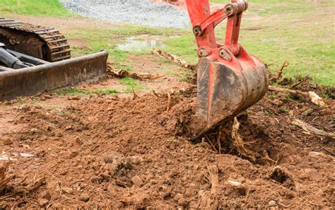 excavator digging up driveways